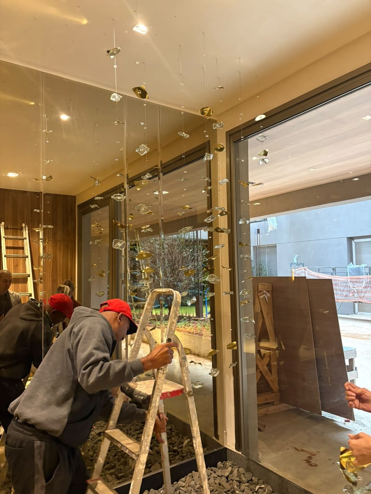 Casa Ibirapuera — Chuva de Cristal e Folhas Douradas — Detalhe da equipe fixando os cristais